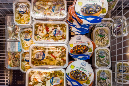 Italy - November 09, 2023: Fish shellfish and mussels precooked and packaged in refrigerated counter for sale in Italian supermarketのeditorial素材