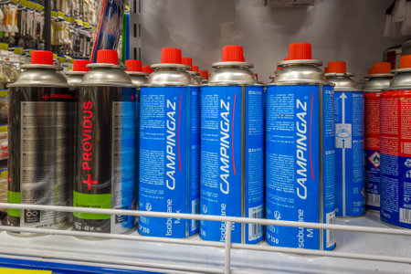 Italy - November 26, 2023: Campingaz gas cartridges from Camping and other brands of butane gas on shelf for sale in supermarketのeditorial素材