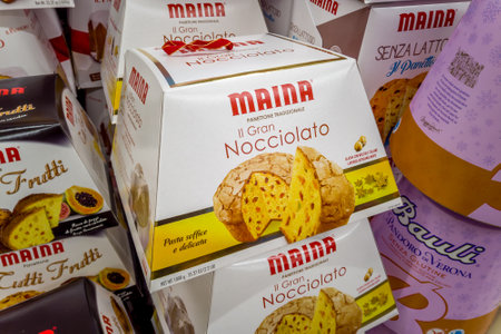 Fossano, Italy - December 04, 2023: Maina panettone and pandoro in packages displayed for sale in Italian supermarket, Maina is famous Italian confectionery industryのeditorial素材