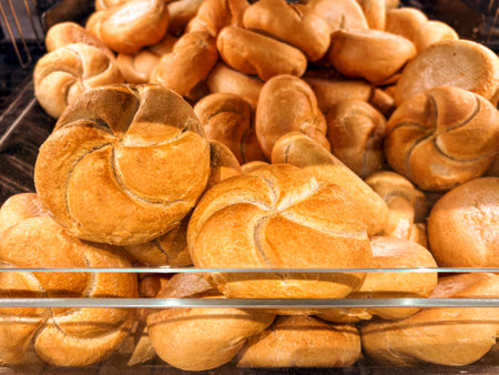 Loaves of Italian bread called rosetta in window self-service dispenser for sale in Italian...