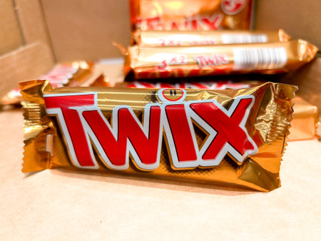 Italy - January 11, 2024: Pack of Twix on blurred background, Twix is a caramel chocolate bar produced by Mars Inc.のeditorial素材