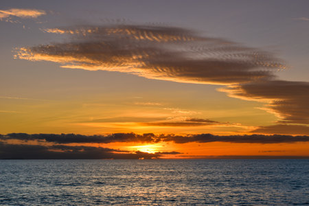 Sunset sky over the sea, panorama with cloud colored sky over blue seaの写真素材
