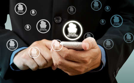 Businessman touch smart phone in hand with social network
