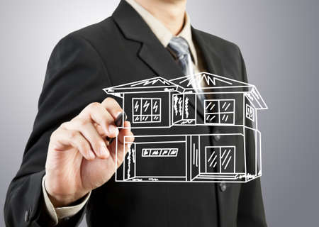 Businessman hand drawing houseの写真素材