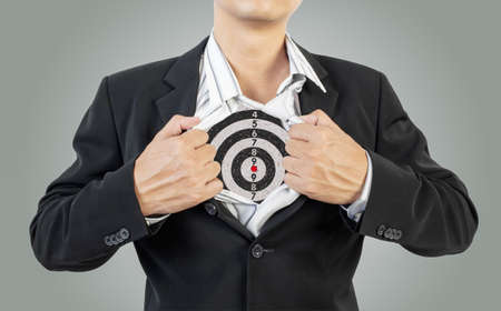 businessman showing target under shirtの写真素材