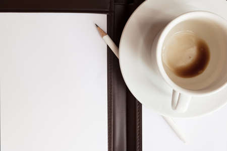 blank white notebook, pen and cup of coffeeの写真素材