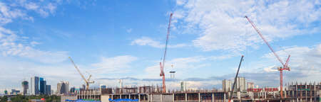 Construction site with crane worker and building as panoramaの写真素材
