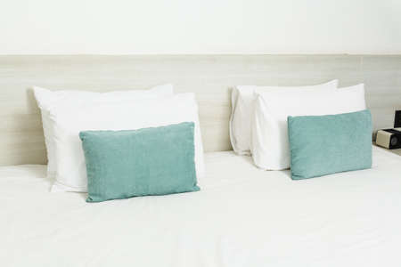 White and green pillows on bedの写真素材