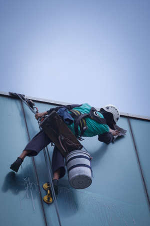 group of workers cleaning windows service on high rise buildingの写真素材