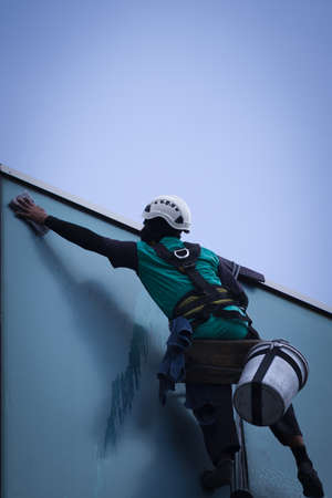 group of workers cleaning windows service on high rise buildingの写真素材