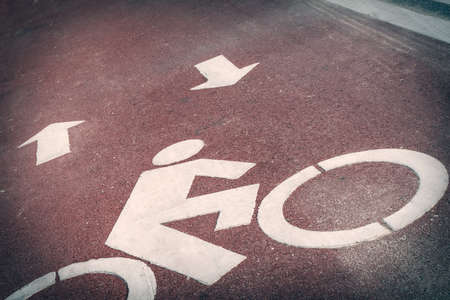 Bicycle lane or path, icon symbol on red asphalt roadの写真素材