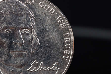 US American coin with wording "in God we trust" on black backgroundの写真素材