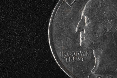 US American coin with wording "in God we trust" on black backgroundの写真素材