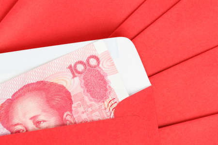 Chinese or 100 Yuan banknotes money in red envelope, as chinese new year backgroundの写真素材