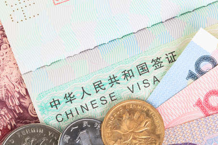 Chinese or Yuan banknotes money and coins from China's currency with visa for travel concept, close up view as backgroundの写真素材