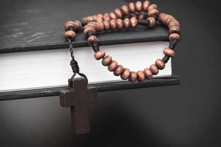 Christian cross necklace on Holy Bible book, Jesus religion concept as good friday or easter...