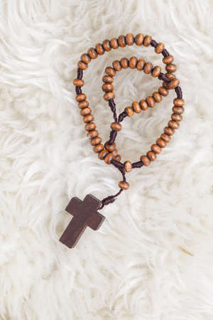 Christian cross necklace on sheep wool, Jesus religion concept as good friday or easter festivalの写真素材