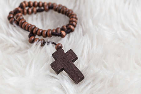 Christian cross necklace on sheep wool, Jesus religion concept as good friday or easter festivalの写真素材