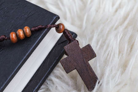 Christian cross necklace on Holy Bible book, Jesus religion concept as good friday or easter...