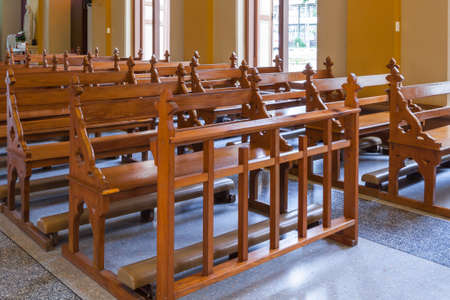 Wood Bench of Catholic church, people can pray for god jesusの写真素材