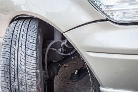 Car crash accident, impact to front wheel axle and bumper is broken cannot drive, insurance safety conceptの写真素材