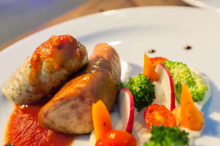 Grilled Mixed German Sausages on white plate for Main Dishesの写真素材