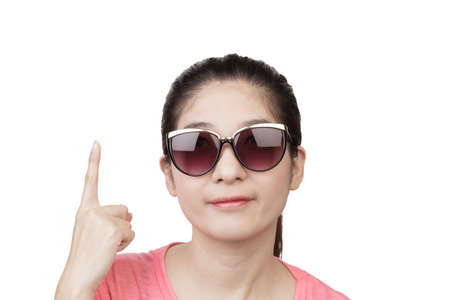 Asian Woman smiling and wearing glasses, finger point up on white backgroundの写真素材