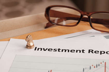 Investment Report letter document and eyeglass document is mockupの写真素材
