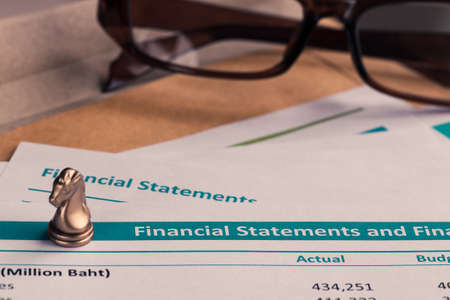 Financial statement letter on brown envelope and eyeglass business concept document is mockupの写真素材