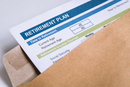 Retirement Planning letter in brown envelope opening business conceptの写真素材