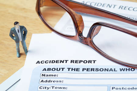 Accident report application form and pen on brown envelope and eyeglass business insurance and risk concept document is mockupの写真素材