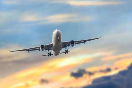 Passenger business airplane take off and flying in sky sunset, use for air transport, journey and travel conceptの写真素材