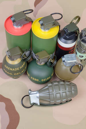 All explosives, weapon army,standard time fuze, hand grenade on camouflage background, top viewの写真素材
