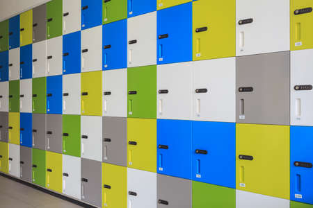 row of colorful lockers and security password code on door for safety conceptの写真素材