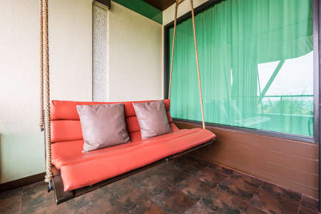swing sofa furnish, and leather pillow for decoration and relax at balconyの写真素材