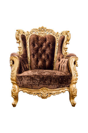 Old vintage brown velvet classic armchair with gold color isolated on white backgroundの写真素材