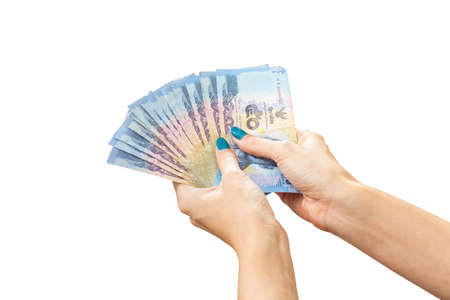 Thai Banknote money in female hand, isolated on white backgroundの写真素材