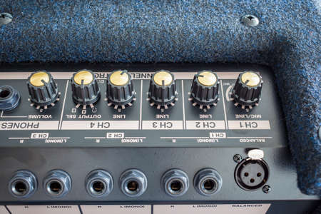 Button of Keyboard Power Amplifier, closeup view backgroundの写真素材