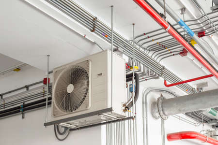 air conditioner compressor installed and hanging on ceiling wall
