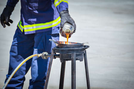 fire trainer teach pouring oil into pan flames for conflagration preventive extinguish, safety conceptの写真素材