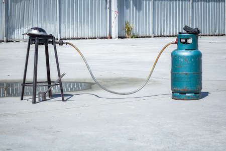 gas tank cylinder balloon connect with pan on gas stove for cooking outdoorの写真素材