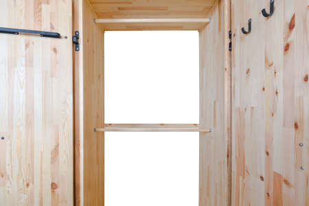 Empty wooden wardrobe and cloth hanging on white backgroundの写真素材