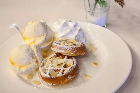 waffle with ice cream, chocolate and vanilla on white plateの写真素材