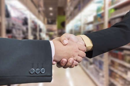 Business handshake with blur background of shopping mallの写真素材