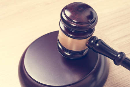 Justice hammer or judge gavel made from wooden on table, vintage theme backgroundの写真素材