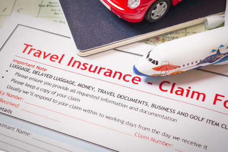 Travel Insurance Claim application form on table, business and risk concept; document,car and plane is mock-upの写真素材