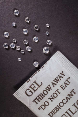 Close up silica gel or desiccant in paper bag on black backgroundの写真素材