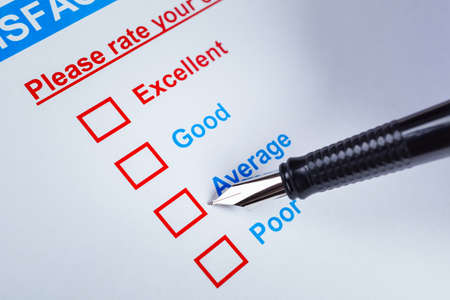 Customer satisfaction survey checkbox with rating and pen pointing at Average, can use any business concept backgroundの写真素材