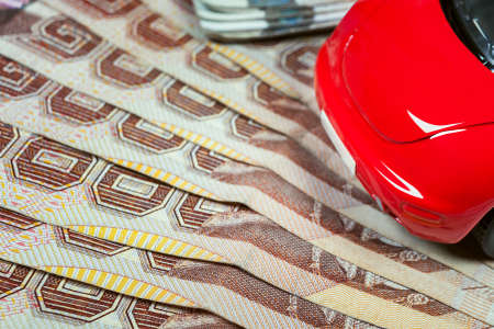 Thai baht banknotes and car mockup closeup on table backgroundの写真素材