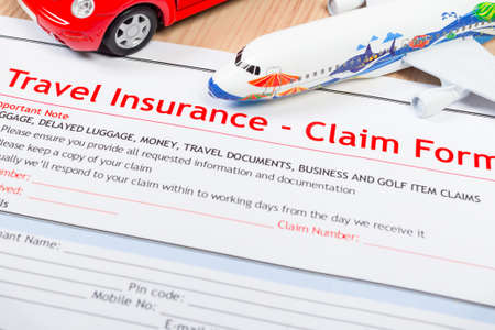 Travel Insurance Claim application form on table, business and risk concept; document,car and plane is mock-upの写真素材